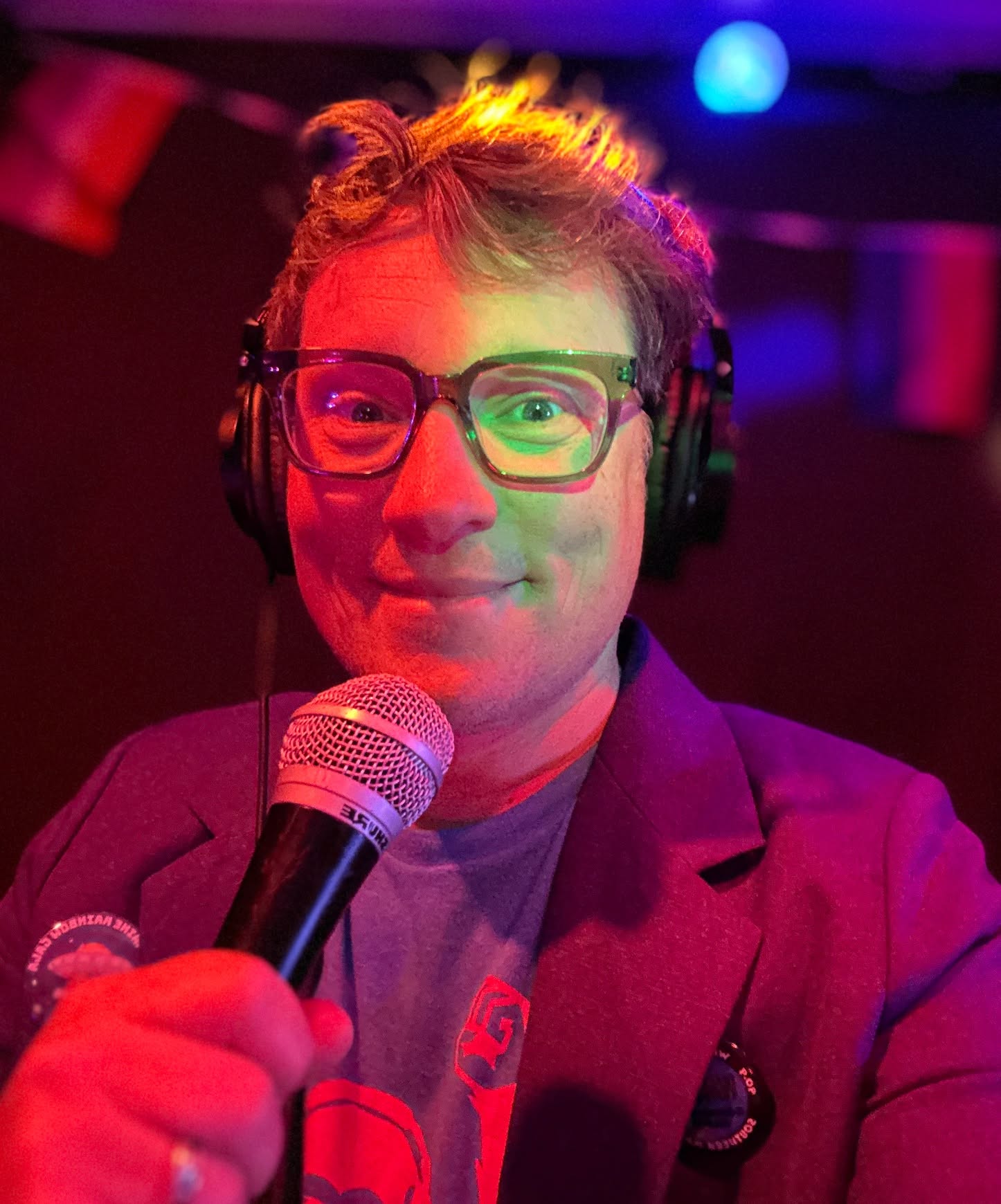 Dj Shaxx holding a microphone on the dance floor.