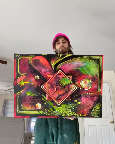 Slaythoven_bass holding up a piece of his killer artwork.